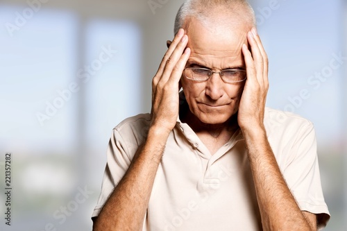 Portrait of a mature man holding his head in pain