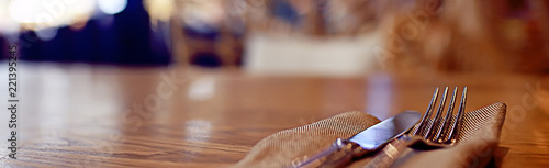 serving in the restaurant, fork and knife / interior view of the restaurant with a table served knife and fork on the table in a cafe