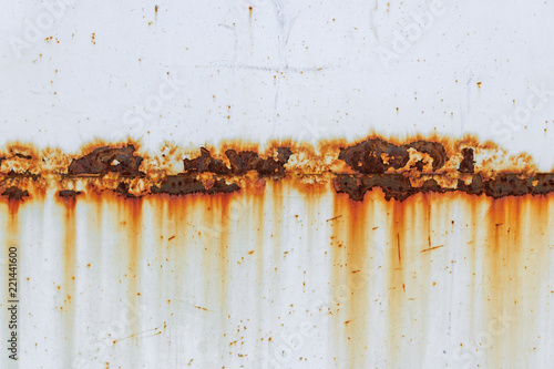 Corrosion of welding seam with red stains on a old white metal sheet. Abstract background