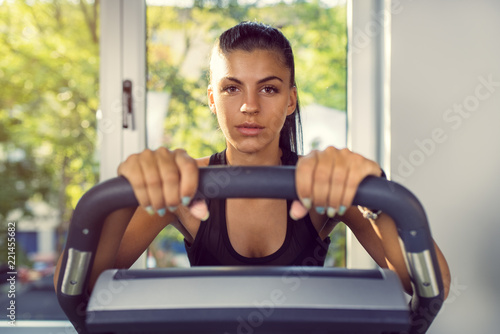 Woman Doing Cardio Exercises on a Stationary Bike at the Gym