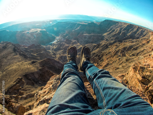 Legs over the Edge at Fish River Canyon. Namibia