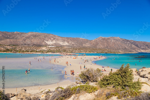 ELAFONISI, CRETE, GREECE - AUGUST 14, 2018: People swimming and rest at Elafonisi beach. The heavenly wild beach with turquoise water.