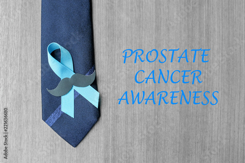 Prostate Cancer Awareness, light Blue Ribbon with mustache and necktie for supporting people living and illness. Men Healthcare and World cancer day concept