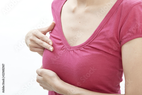 Woman examining herself for breast cancer