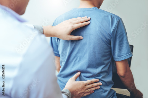 Doctor consulting with patient Back problems Physical therapy concept