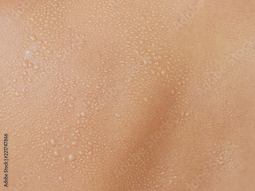 Water drops or sweat on human skin, texture or background 