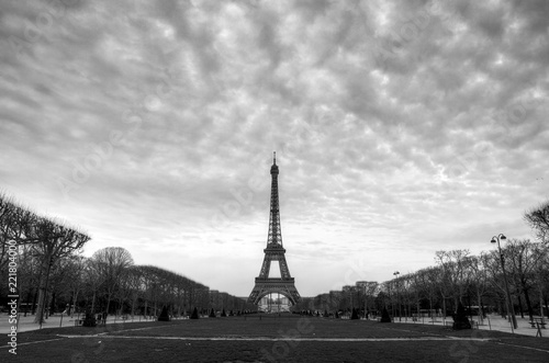 Beautiful cityscape of the Eiffel tower on a cloudy winter day in Paris in black and white 