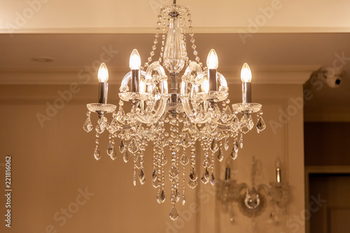 Chrystal chandelier lamp on the ceiling in Dining room Adjusting the image in a Luxury tone .Decorative elegant vintage and Contemporary interior Concept.