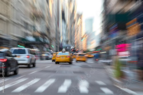 Abstract blurred scene with taxis in motion through the streets of New York City