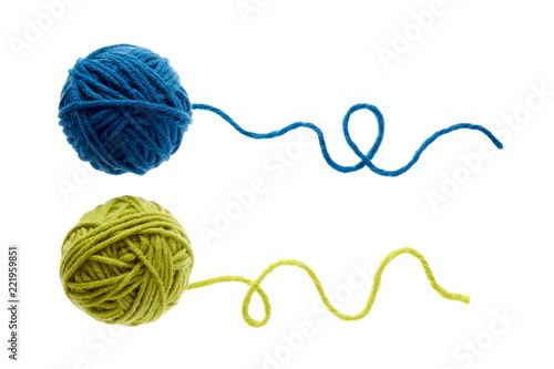 Blue and green woolen balls over white background.