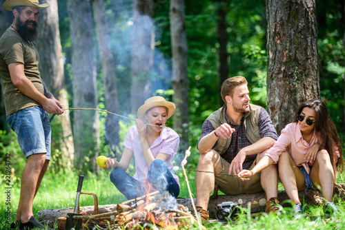 Halt for snack during hiking. Camping and hiking. Company friends relaxing and having snack picnic nature background. Great weekend in nature. Company hikers relaxing at picnic forest background