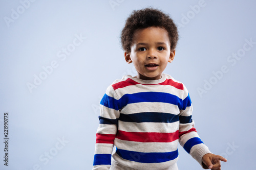 Cute child. Joyful nice afro American boy looking at you while feeling excited