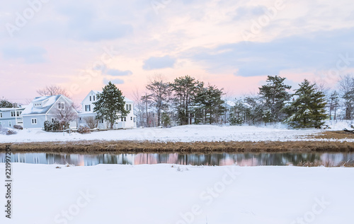 Lovely houses by the river on a winter evening. A traditional view of Maine. USA. 
