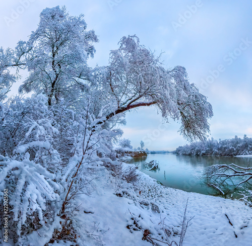 Snowfall on the river. The Terek River in the North Caucasus. Winter New Year's dawn with fluffy snow.