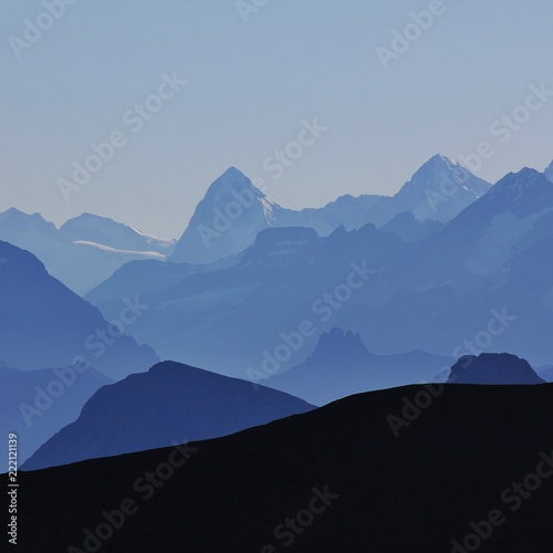 Mountain peaks of the Bernese Oberland at sunrise. View from Glacier 3000, Switzerland. 