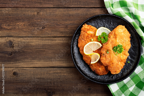 Homemade breaded german weiner schnitzel with potatoes. top view