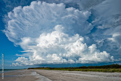 Towering cumulus cloud over dark skies