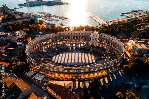 Pula Arena at sunset - aerial view taken by a professional drone. The Roman Amphitheater of Pula, Istria, Croatia