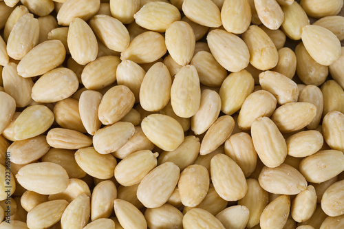 peeled almonds on wooden surface