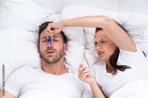 Woman Trying To Stop Man's Snoring With Clothespin