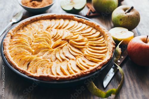 Traditional apple tart on rustic wooden background