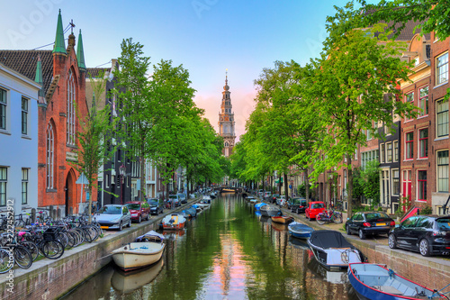 Beautiful Groenburgwal canal in Amsterdam with the Soutern church (Zuiderkerk) at sunset in summer