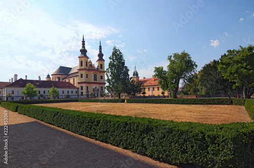 Landscape photo of Piarist Church of the Discovery. View from the park in the Castle Litomysl by summer day. Baroque church was built 1714 and 1725 by Italian architect Giovanni Battista Alliprandi