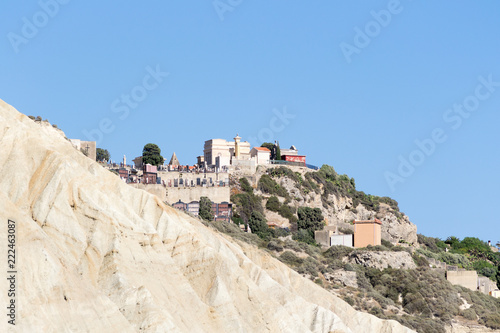 View of a little hill in the city of Licata near Gela in Sicily (Italy). On top of it is located the monumental cemetary of the town visible from far away