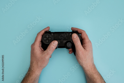 Man playing video game holding gaming controller in hands