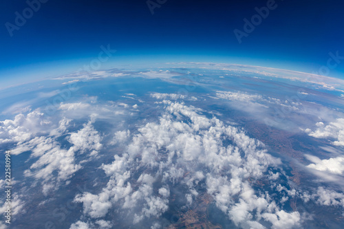 Curvature of planet earth. Aerial shot. Blue sky and clouds