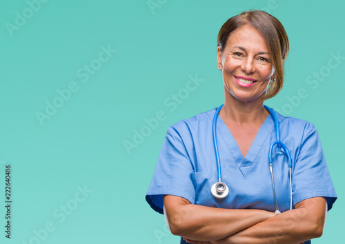 Middle age senior nurse doctor woman over isolated background happy face smiling with crossed arms looking at the camera. Positive person.