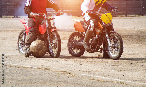Motoball, teens play motoball on motorcycles with a ball, two players