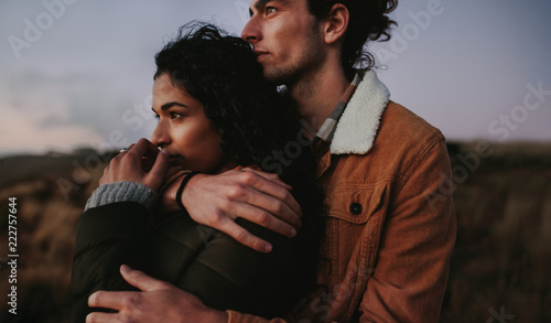 Romantic couple looking landscape view from mountain