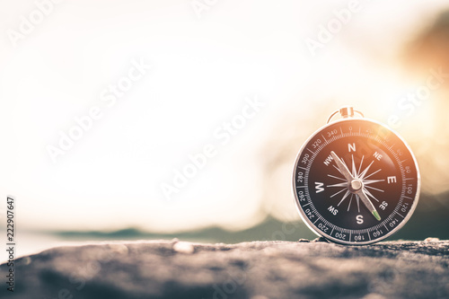 Compass of tourists on mountain at sunset sky.