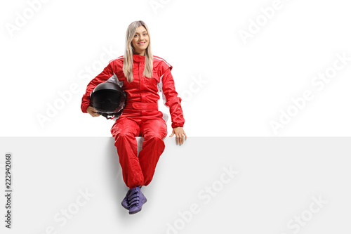 Female racer in a suit sitting on a panel