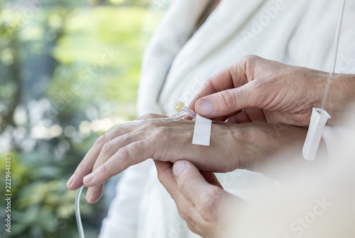 Close-up of a hand with a peripheral venous access catheter