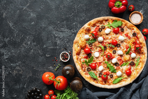 Italian Pizza On Black Concrete Background. Copy Space For Text. Tasty Pizza