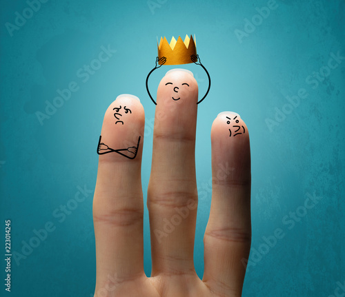 A middle finger is dressing a gold crown on blue background. Concept of success.