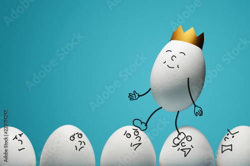 Concept of ambitiousness, careerism. An egg with golden crown walks through heads the white eggs.