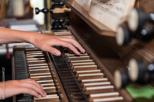 Person plays church organ - detail