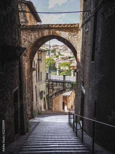 Charming old street of medieval towns of Italy-Perugia in Umbria, gloomy and deserted with huge two-storey arches