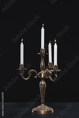 candelabrum with flaming candles on black background