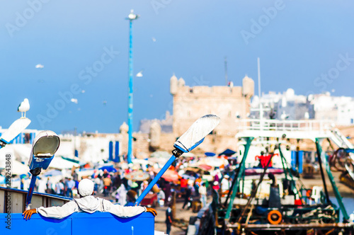 Person relaxing at the port of essaouira in Morocco