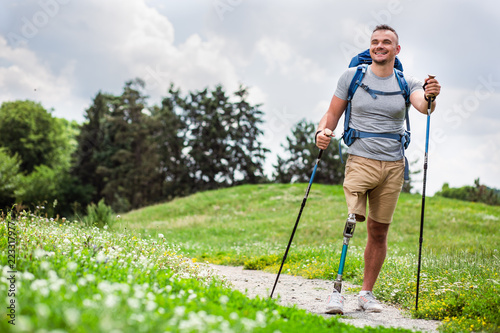 Happy young man with disability trying Nordic walking