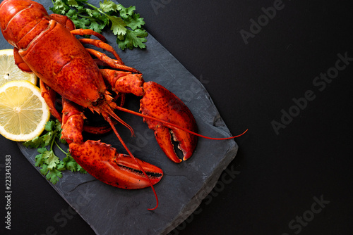 lobster with vegetable and lemon on black slate plate