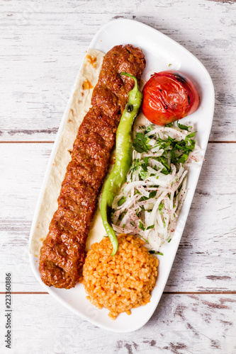 Adana Kebab Served with Green Vegetables in White Plate