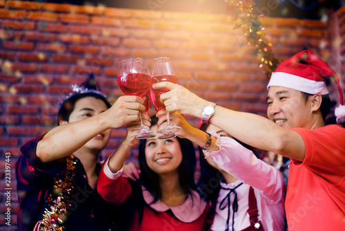 Asian people are celebrating the holiday season happily. Christmas Party and Happy New Year Friendship of friends and family intimacy Make fun, relax and enjoy. The annual success of the company.
