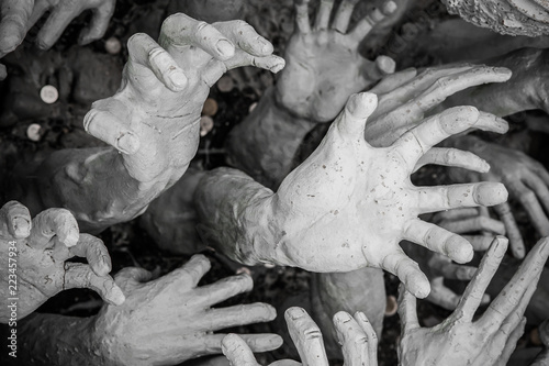 Sculpture of hundreds outreaching hands. White Temple, Chiang Rai Thailand
