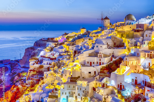 Traveling and New Destinations Concepts. Romantic Sunset at Santorini Island in Greece. Image Taken in Oia Village At Dusk. Amazing Sunset with White Houses and Windmills in Frame.