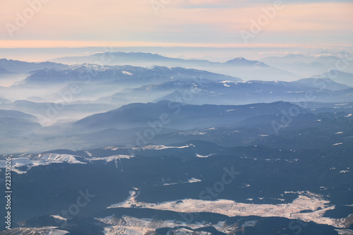 Alps with snow and mist in the valleys,